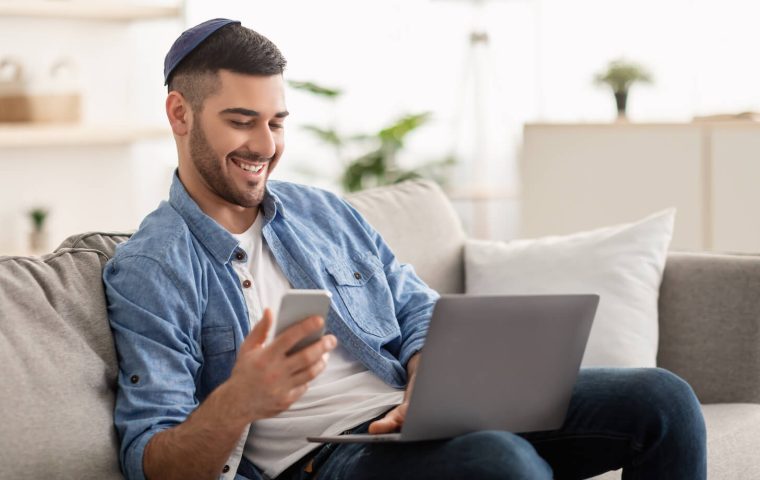 happy-jewish-man-using-mobile-phone-and-laptop-2021-07-07-03-37-17-utc.jpeg
